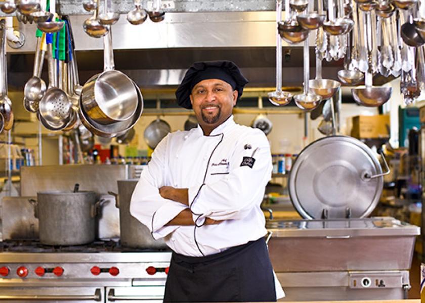 Chef in fully-stocked kitchen
