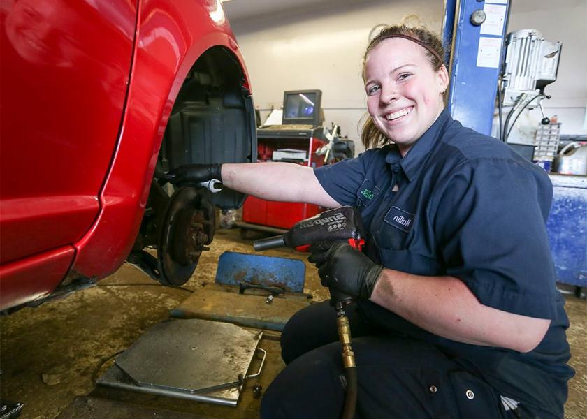Female Automotive Service Technician working indoors