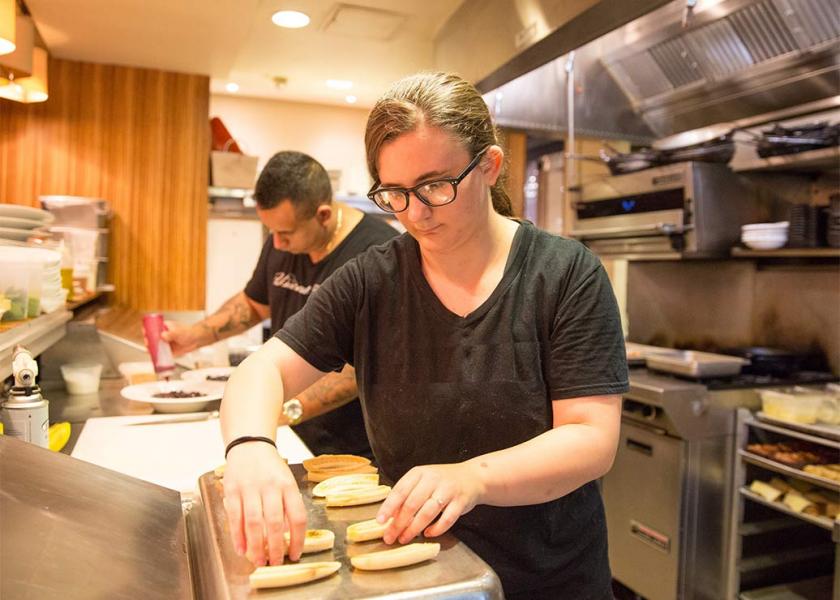 Male and female cooks in kitchen